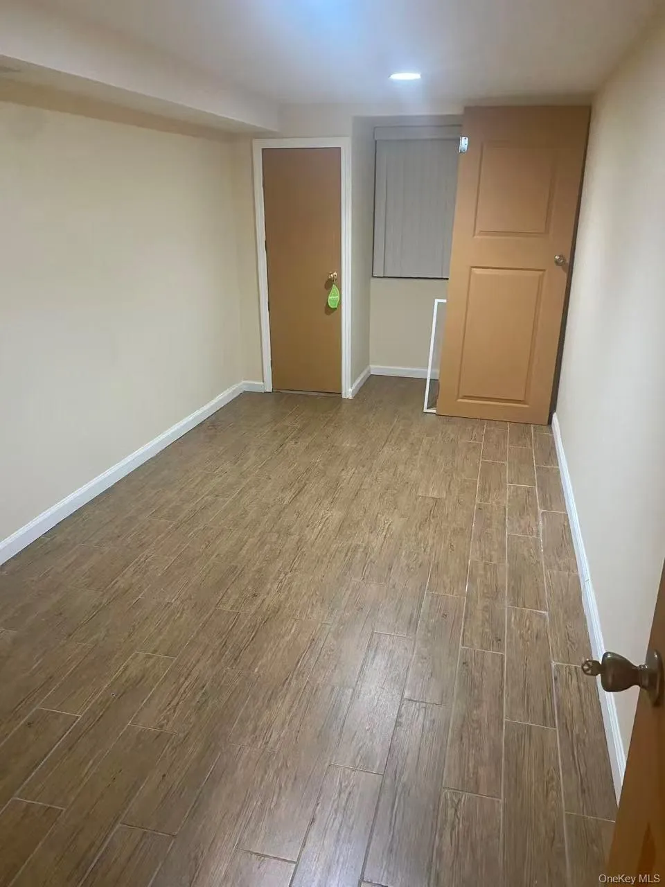 Empty room featuring wood finished floors and baseboards Empty room featuring wood finished floors and baseboards