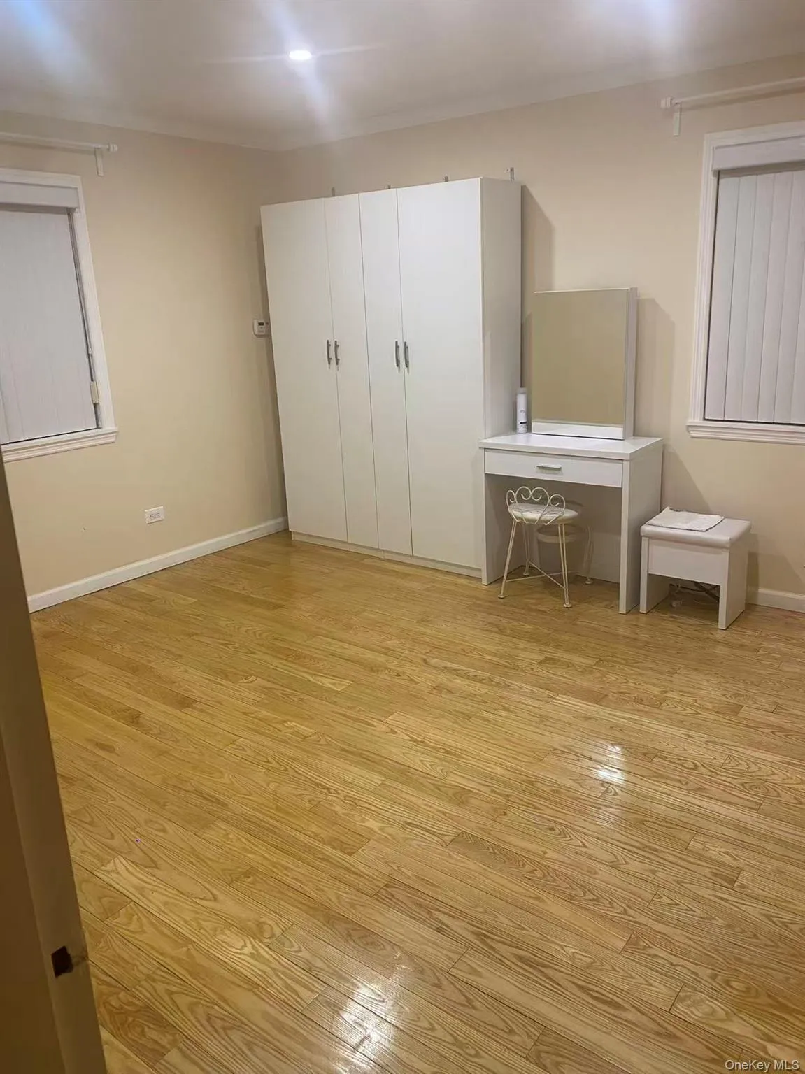 Unfurnished bedroom with light wood finished floors and ornamental molding Unfurnished bedroom with light wood finished floors and ornamental molding