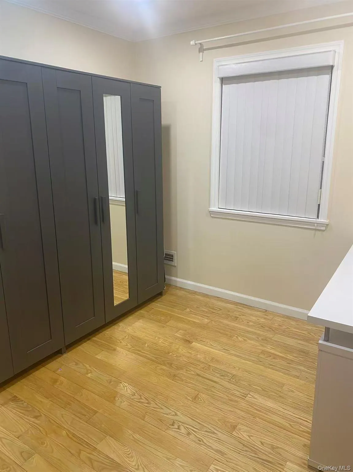 Unfurnished bedroom featuring baseboards and light wood-style floors Unfurnished bedroom featuring baseboards and light wood-style floors