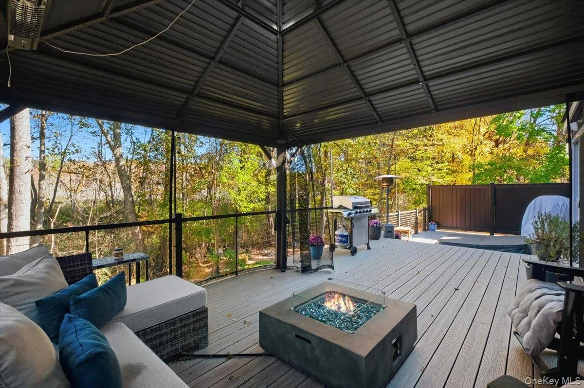 Deck with grilling area and an outdoor living space with a fire pit Deck with grilling area and an outdoor living space with a fire pit