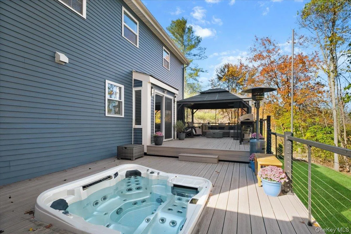 Wooden terrace featuring a gazebo and area for grilling Wooden terrace featuring a gazebo and area for grilling