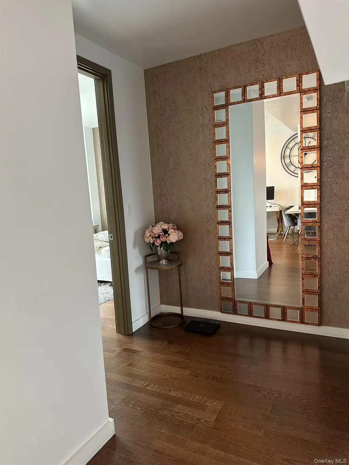 Hallway with dark wood-style floors and a desk Hallway with dark wood-style floors and a desk