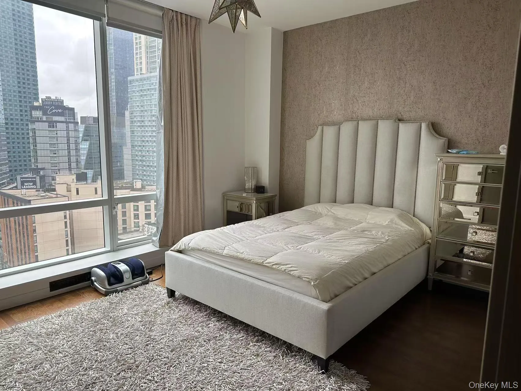 Bedroom featuring wood finished floors and a city view Bedroom featuring wood finished floors and a city view