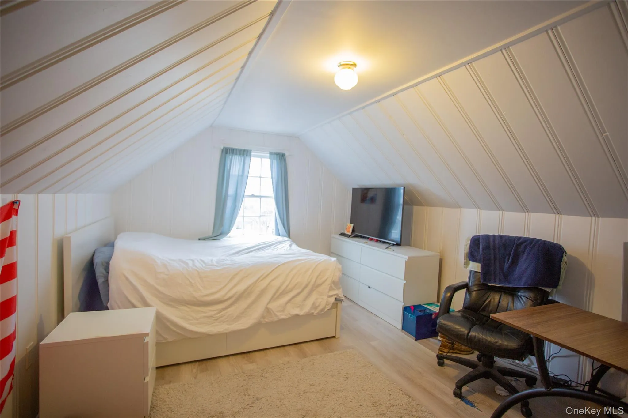 Bedroom with wood finished floors and lofted ceiling Bedroom with wood finished floors and lofted ceiling