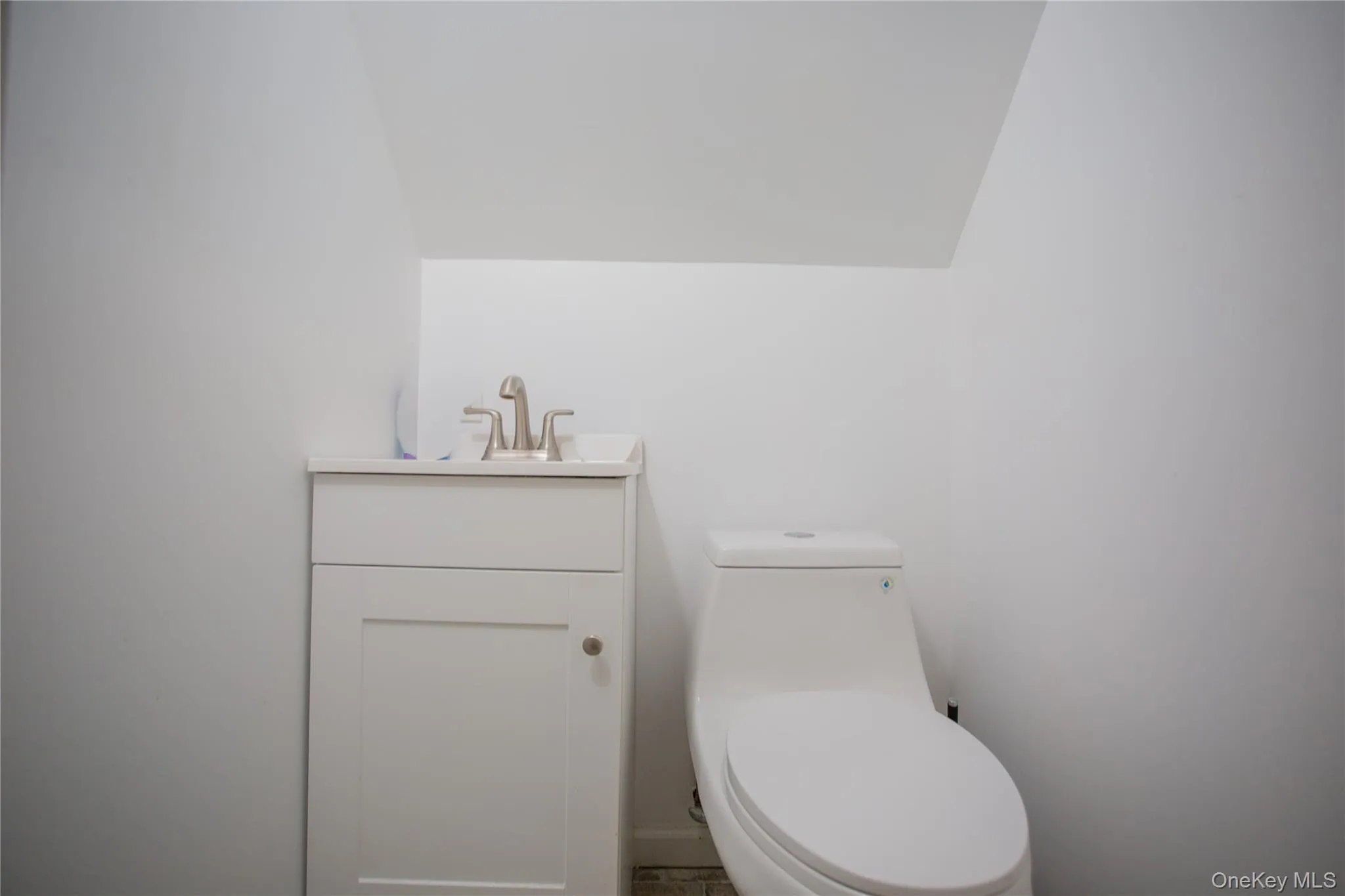 Half bathroom with vanity and toilet Half bathroom with vanity and toilet