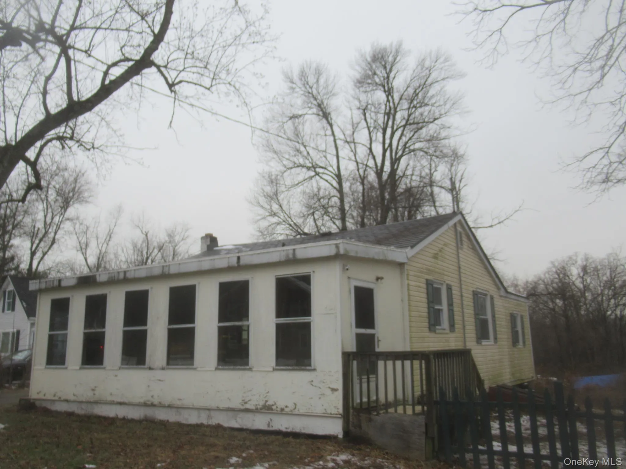 View of property exterior featuring a wooden deck View of property exterior featuring a wooden deck