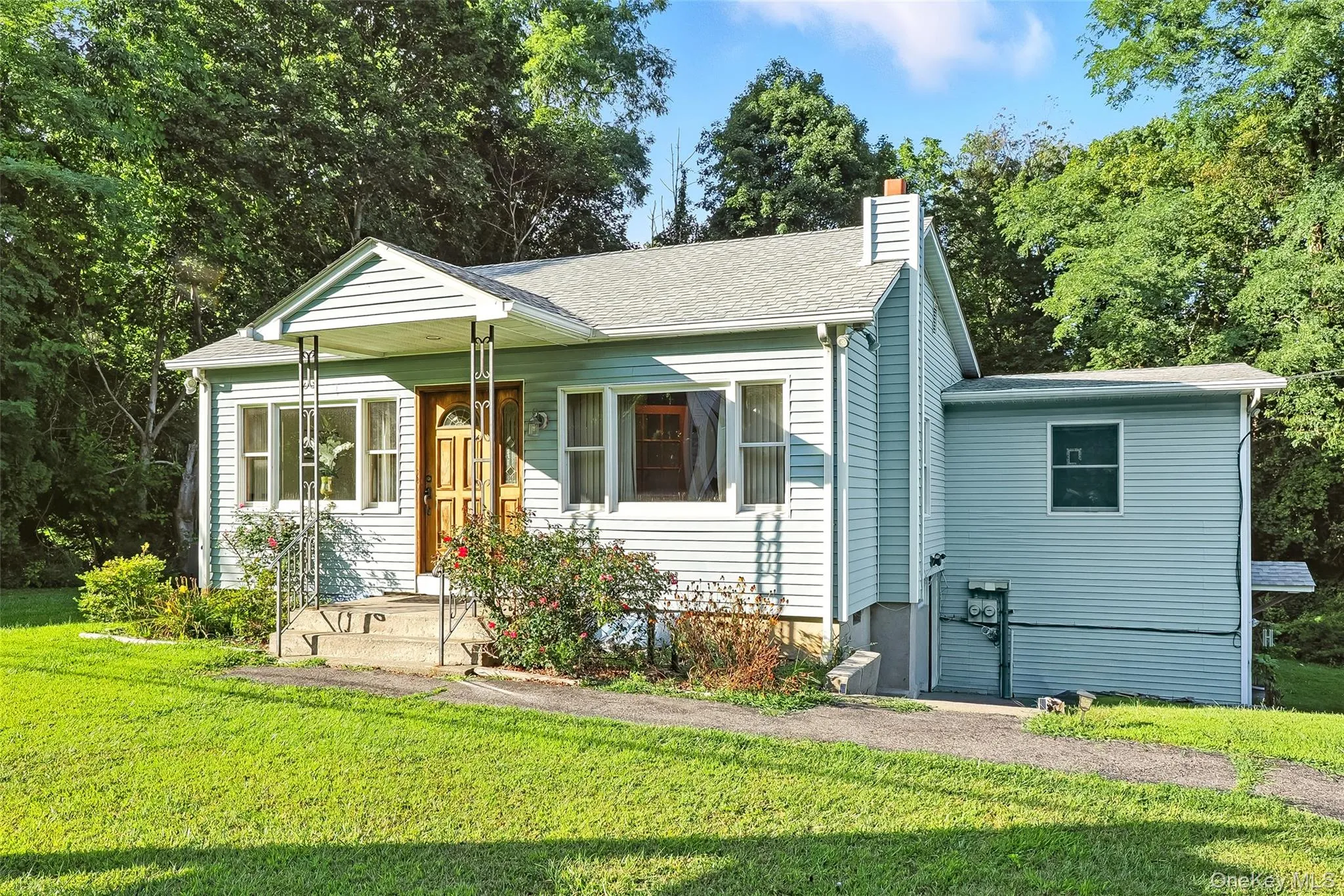 Bungalow-style house with a front yard, a chimney, and a shingled roof Bungalow-style house with a front yard, a chimney, and a shingled roof