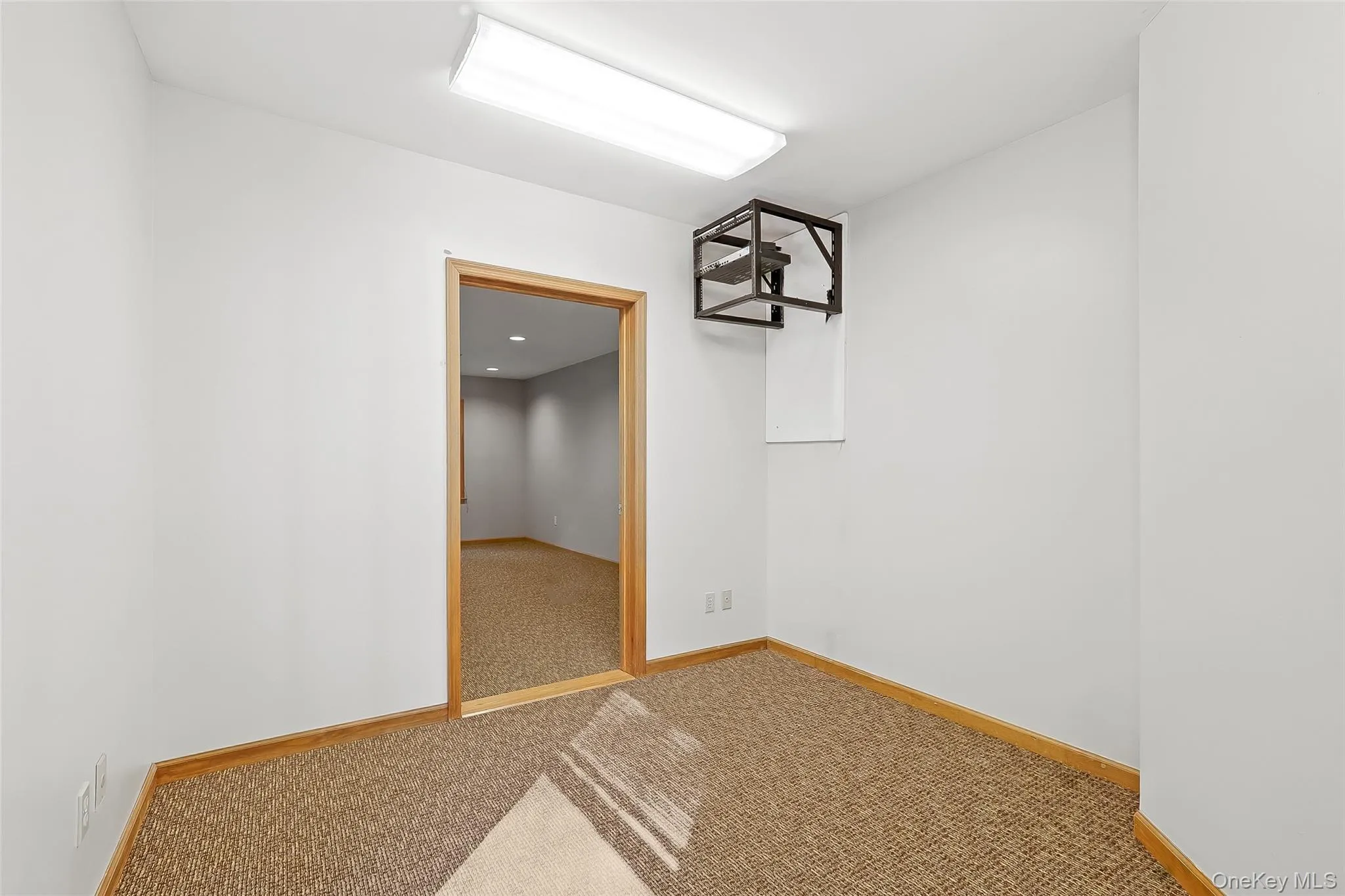 Spare room featuring carpet flooring and baseboards Spare room featuring carpet flooring and baseboards