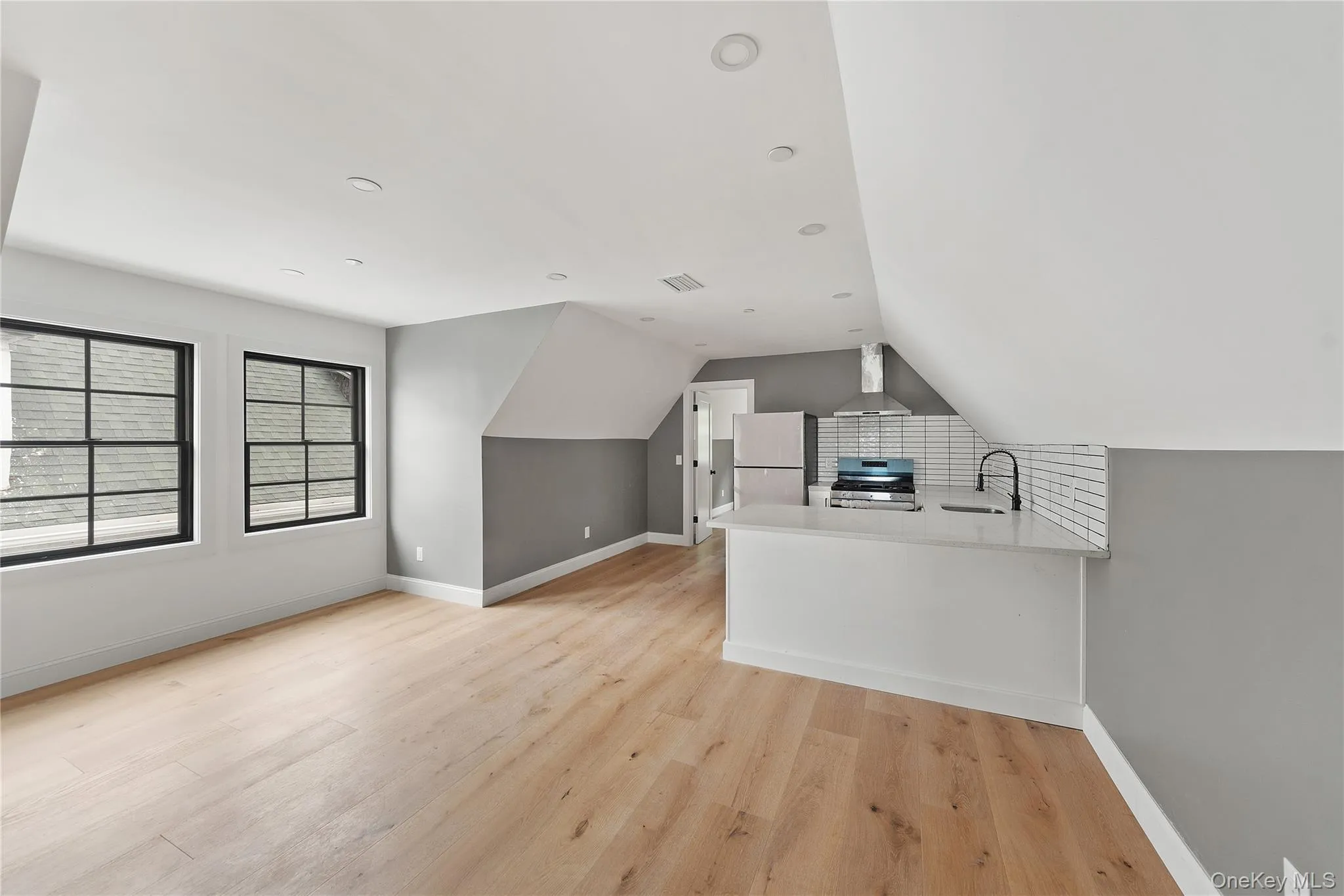 Bonus room with light wood-style floors and vaulted ceiling Bonus room with light wood-style floors and vaulted ceiling