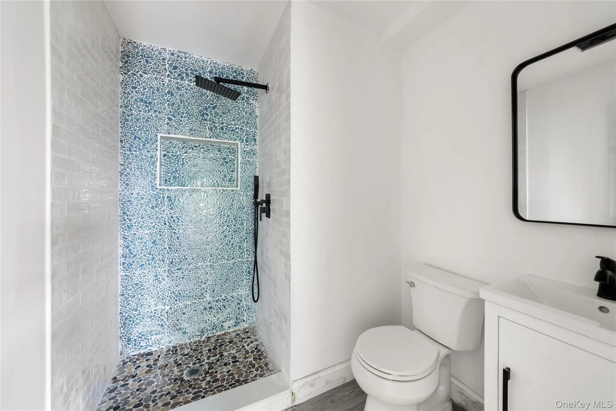 Bathroom featuring a walk in shower and vanity Bathroom featuring a walk in shower and vanity