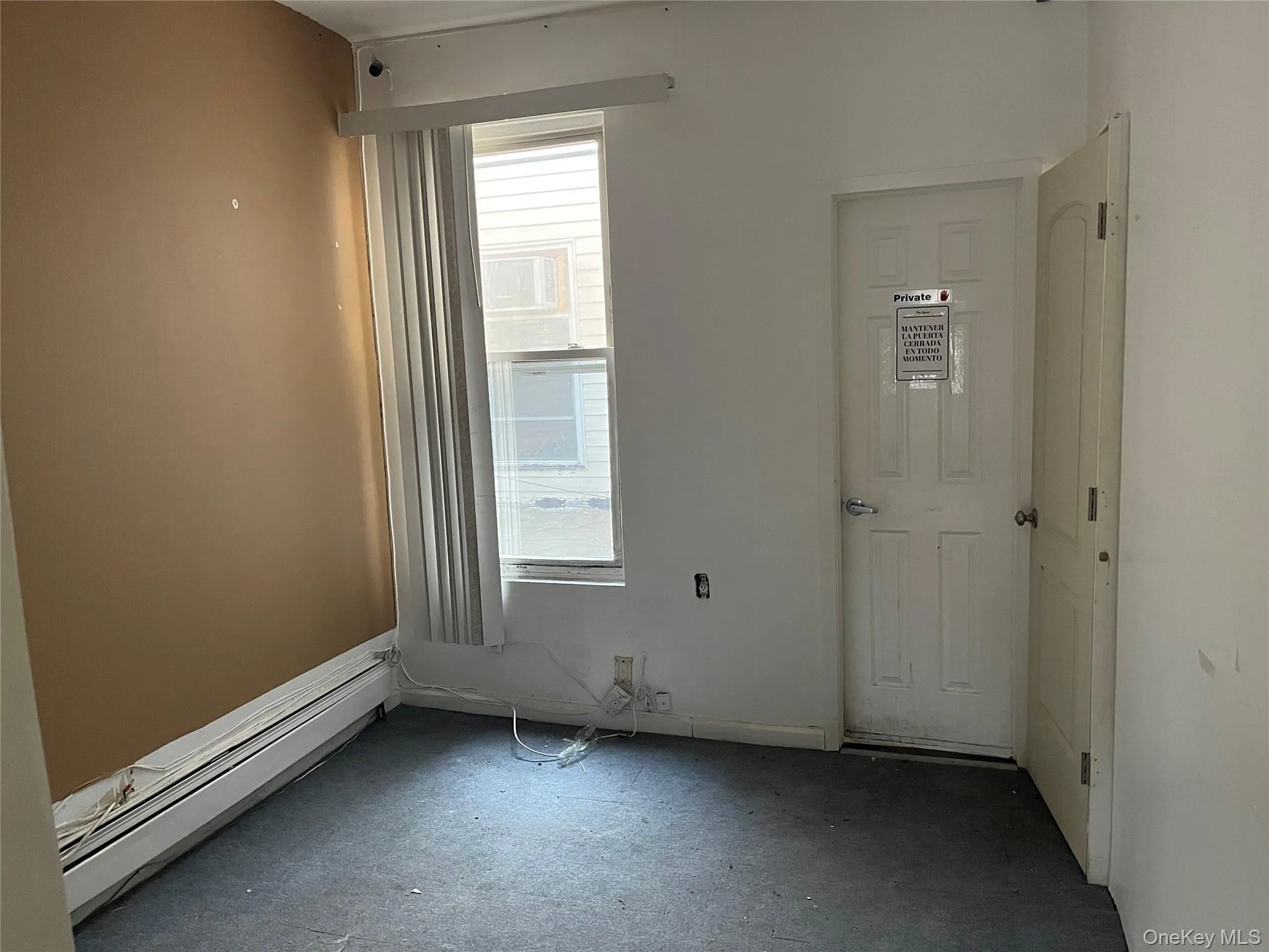 Empty room featuring a baseboard radiator Empty room featuring a baseboard radiator