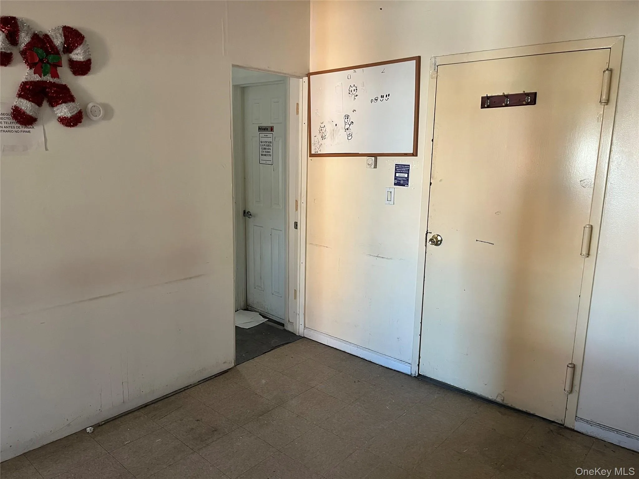 Hallway featuring tile patterned floors Hallway featuring tile patterned floors