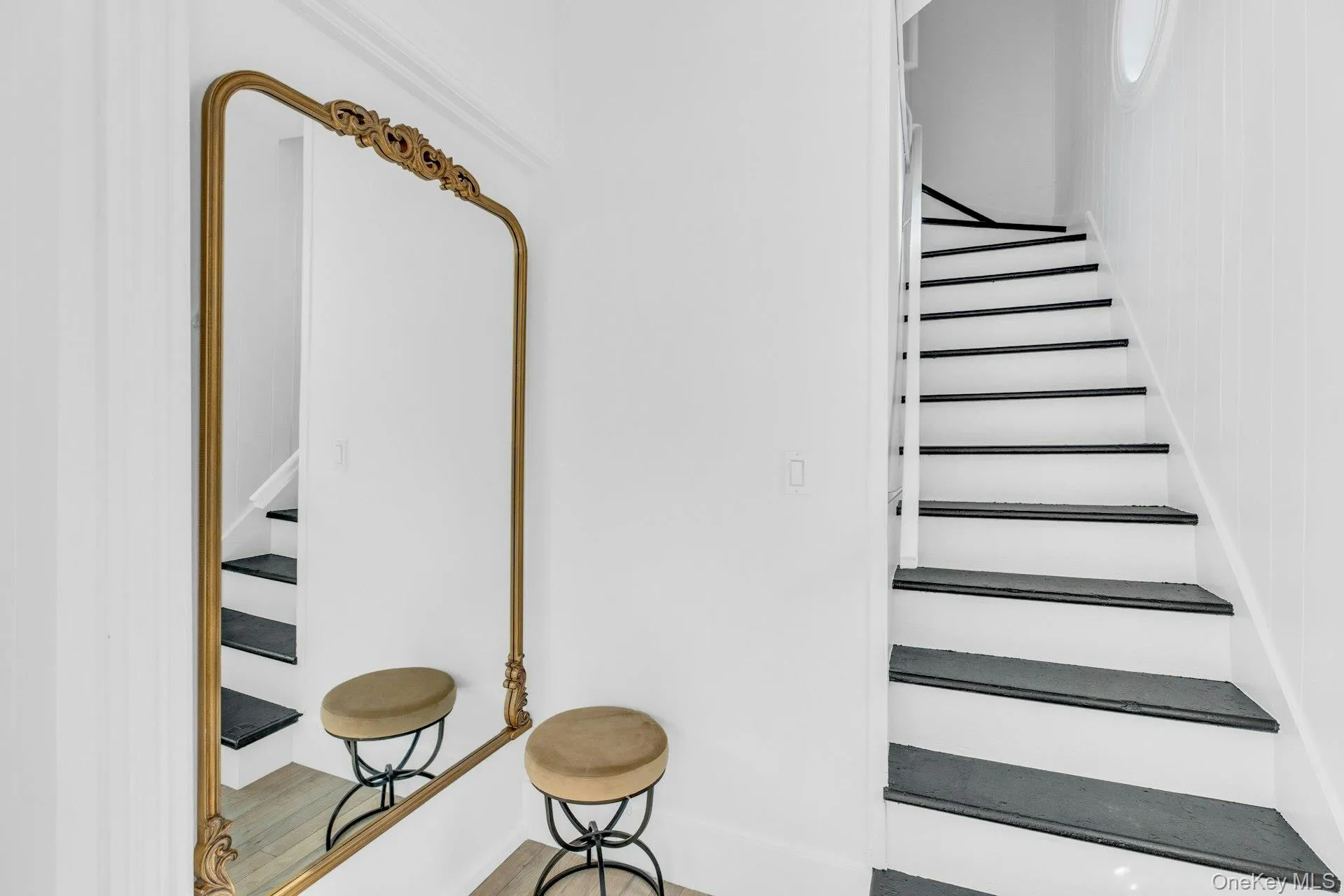 Stairs featuring wood finished floors Stairs featuring wood finished floors