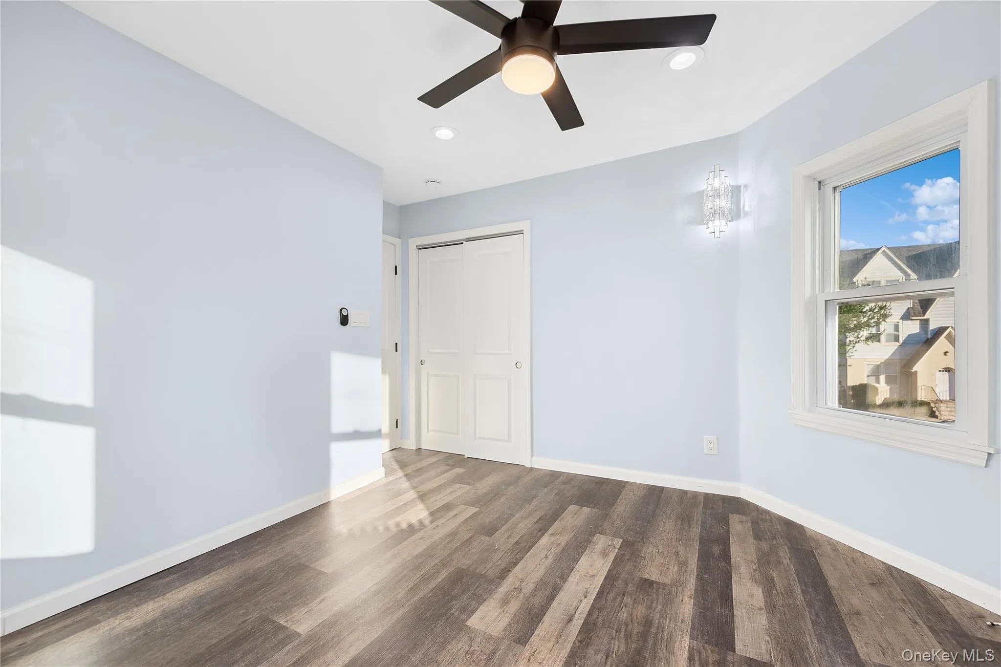 Empty room featuring dark wood-style flooring, recessed lighting, and a ceiling fan Empty room featuring dark wood-style flooring, recessed lighting, and a ceiling fan