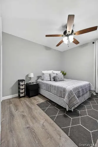 Bedroom featuring wood finished floors and a ceiling fan Bedroom featuring wood finished floors and a ceiling fan