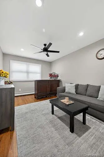 Living room with light wood finished floors, recessed lighting, and ceiling fan Living room with light wood finished floors, recessed lighting, and ceiling fan