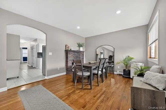 Dining area with arched walkways, light wood-type flooring, and recessed lighting Dining area with arched walkways, light wood-type flooring, and recessed lighting
