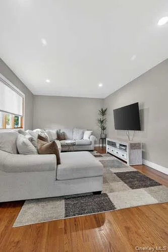 Living area with wood finished floors and recessed lighting Living area with wood finished floors and recessed lighting