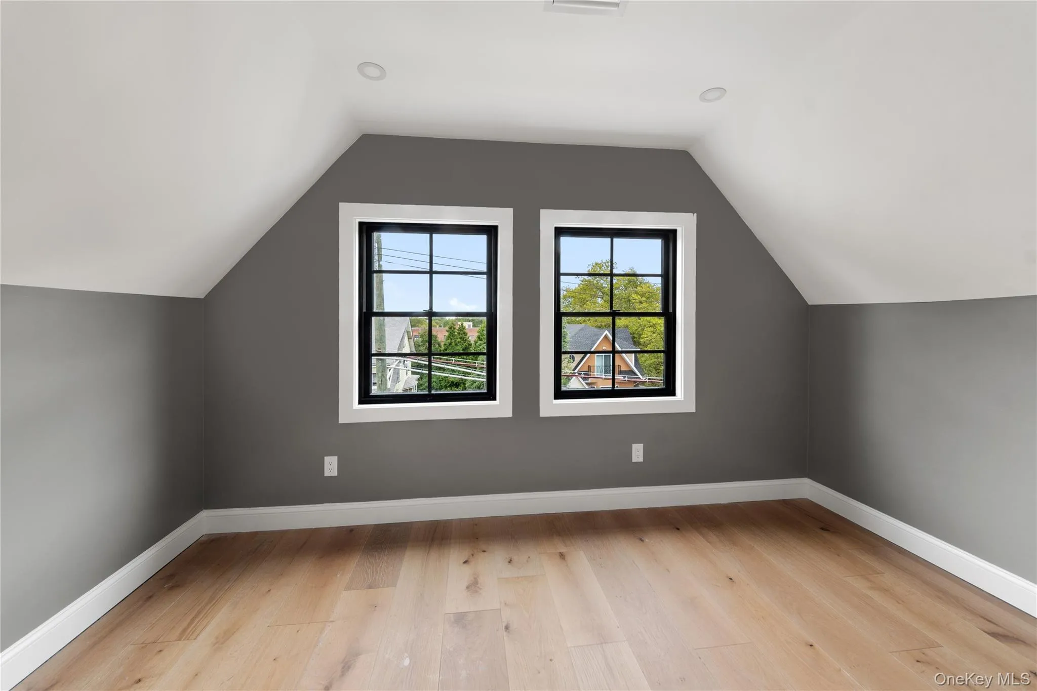 Bonus room with light wood-style flooring and vaulted ceiling Bonus room with light wood-style flooring and vaulted ceiling