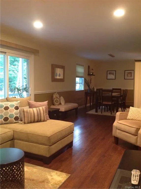 Living room with dark wood-type flooring Living room with dark wood-type flooring