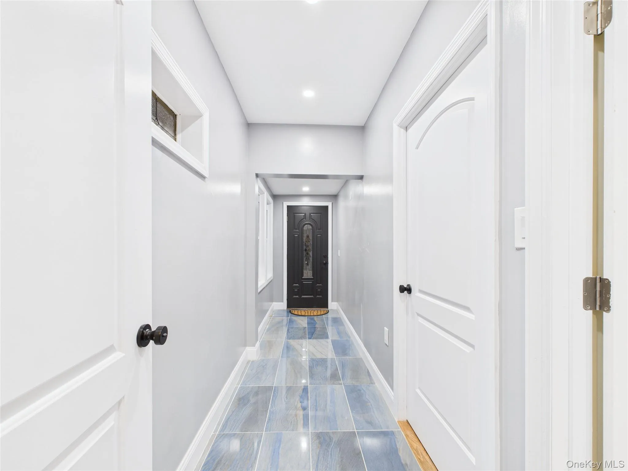 Hallway featuring baseboards and recessed lighting Hallway featuring baseboards and recessed lighting