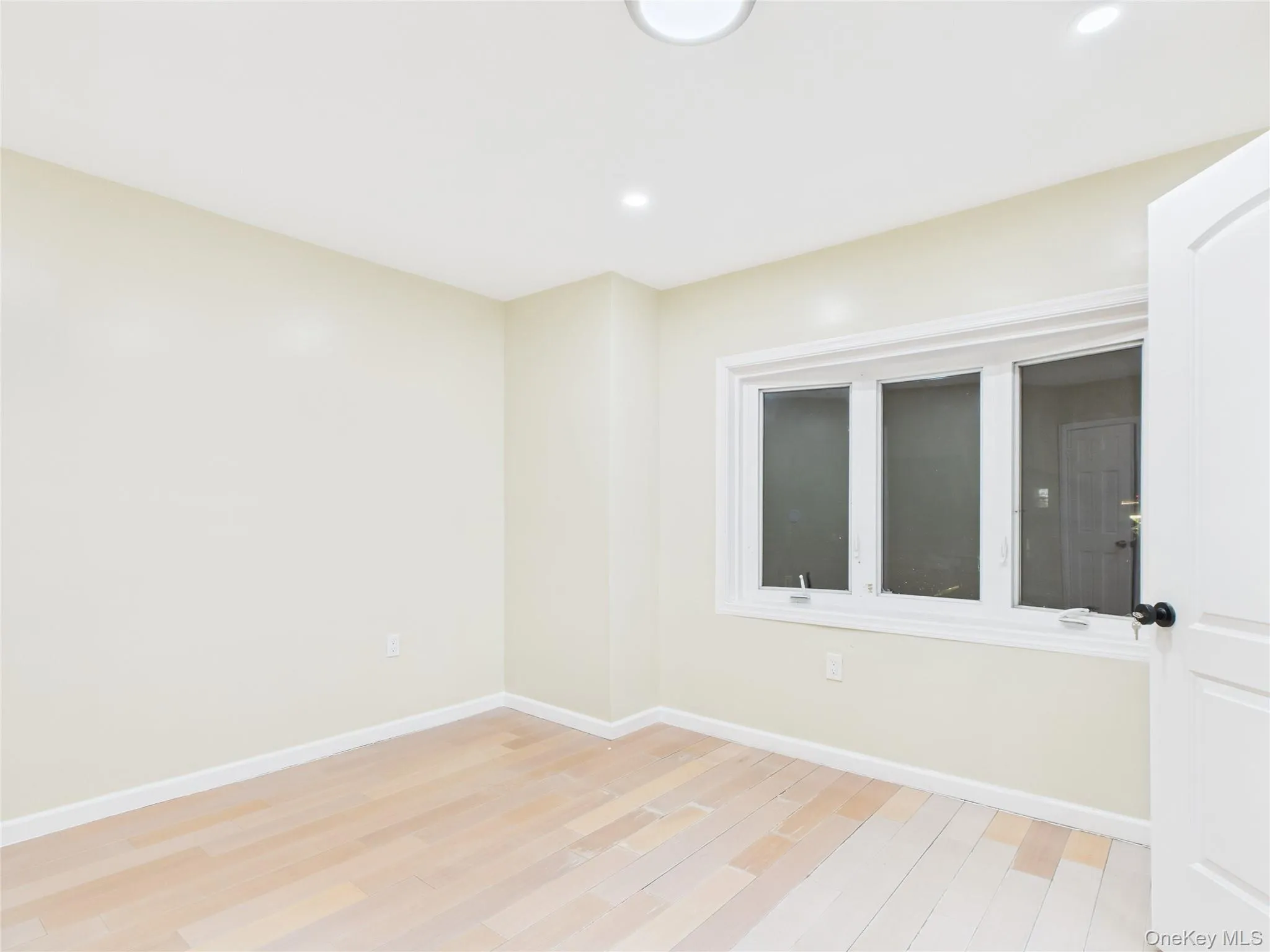 Empty room featuring light wood finished floors and recessed lighting Empty room featuring light wood finished floors and recessed lighting