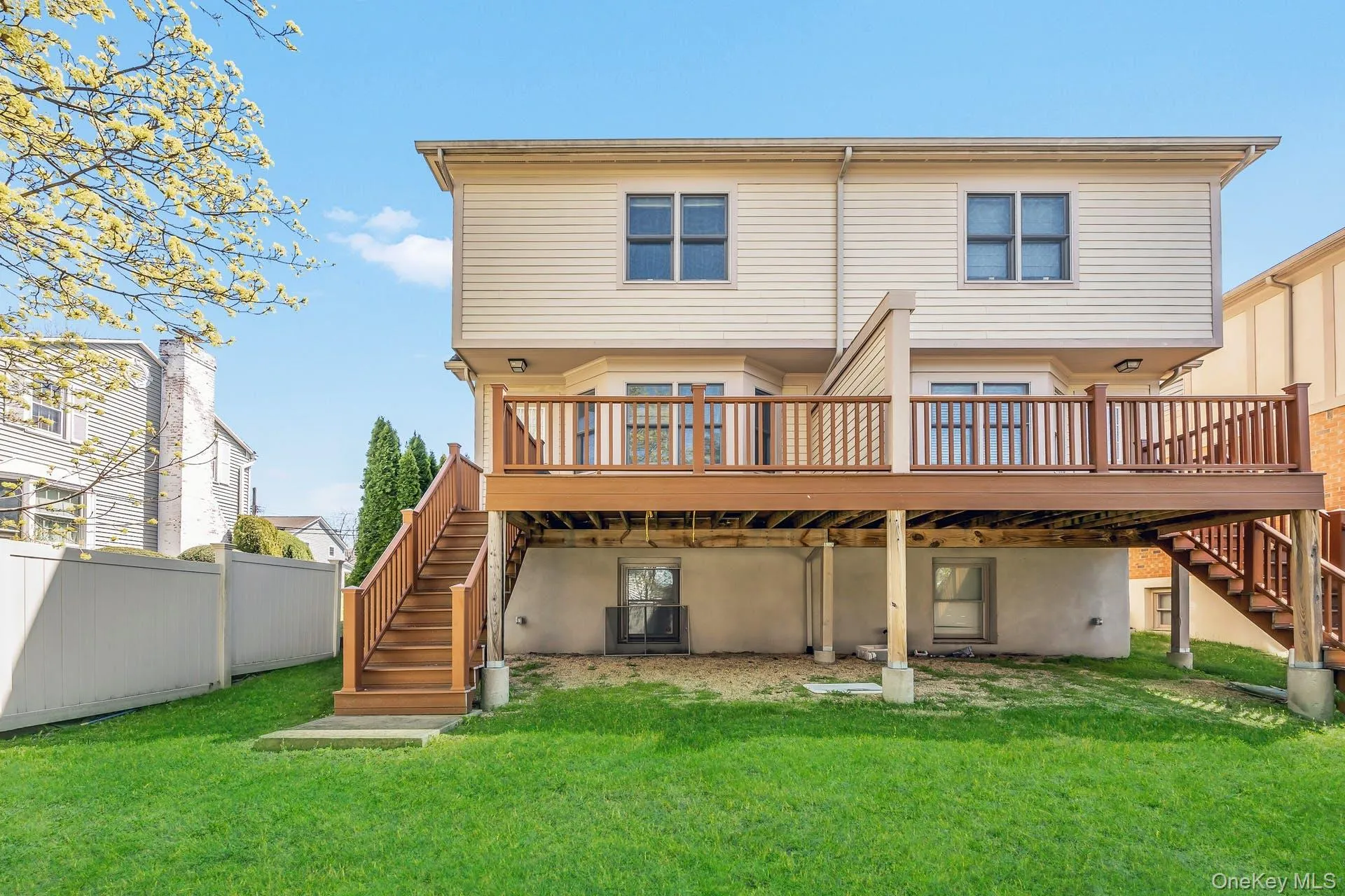 Rear view of property featuring stairs and a wooden deck Rear view of property featuring stairs and a wooden deck