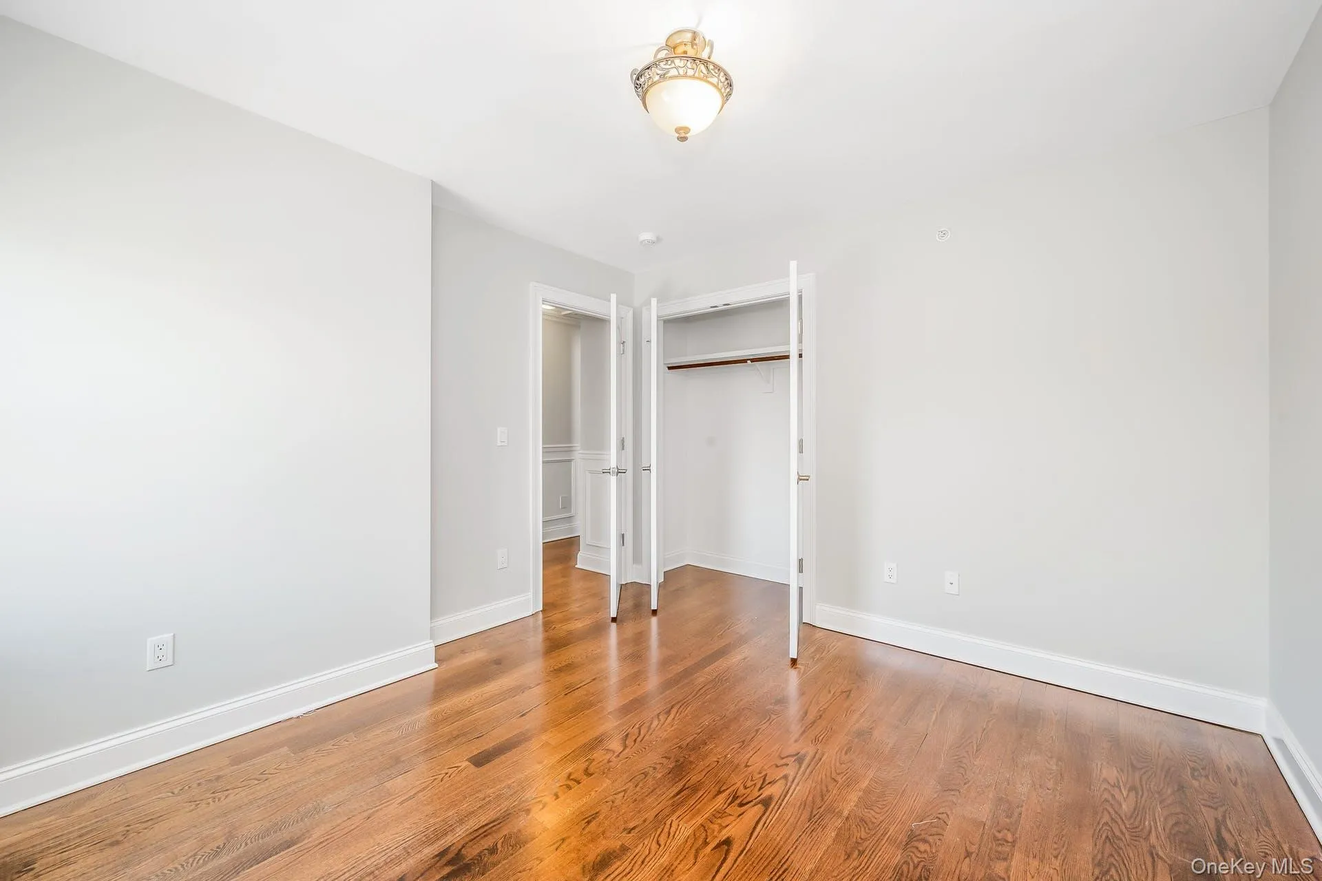 Unfurnished bedroom with light wood-style flooring and a closet Unfurnished bedroom with light wood-style flooring and a closet