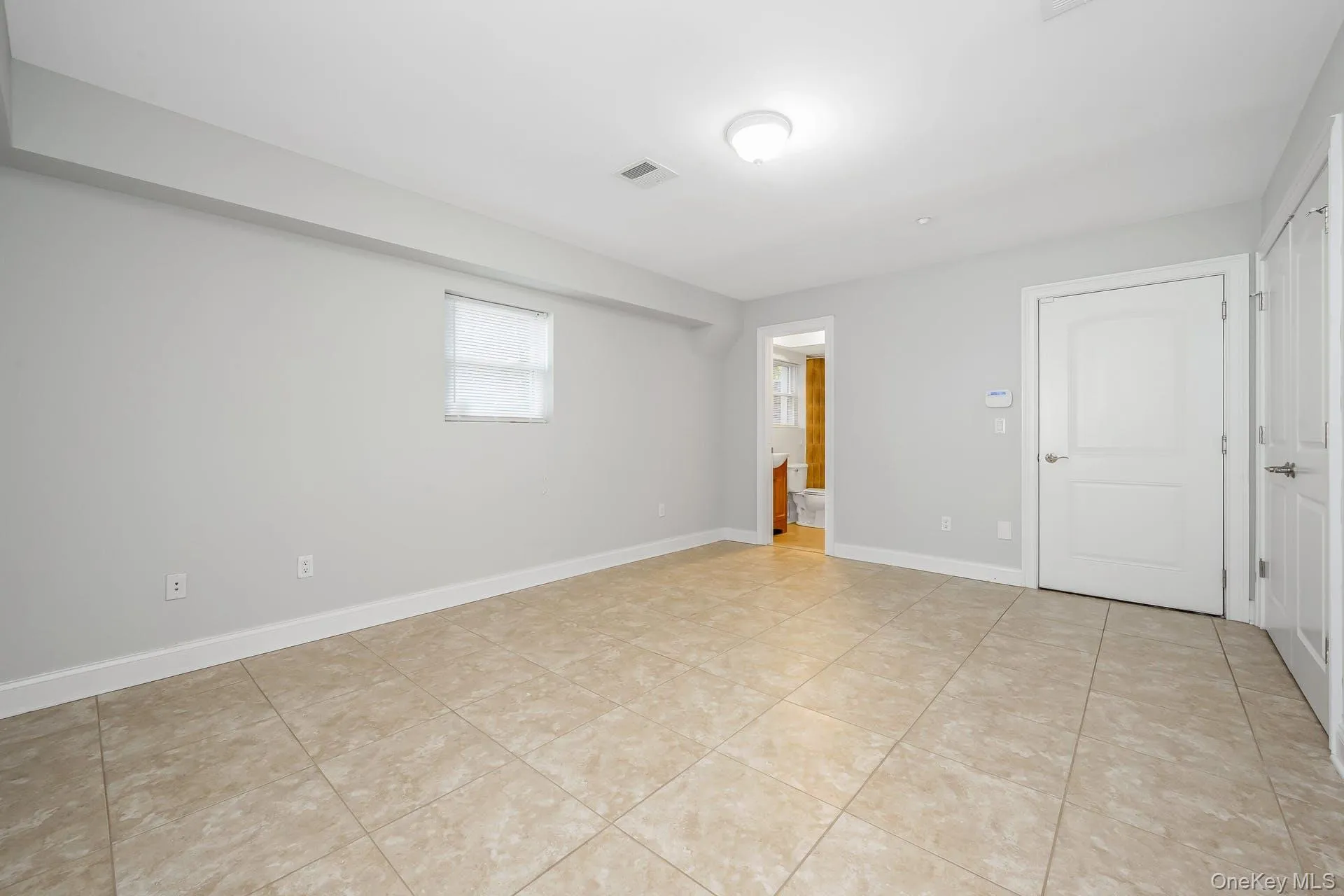 Empty room featuring light tile patterned floors Empty room featuring light tile patterned floors