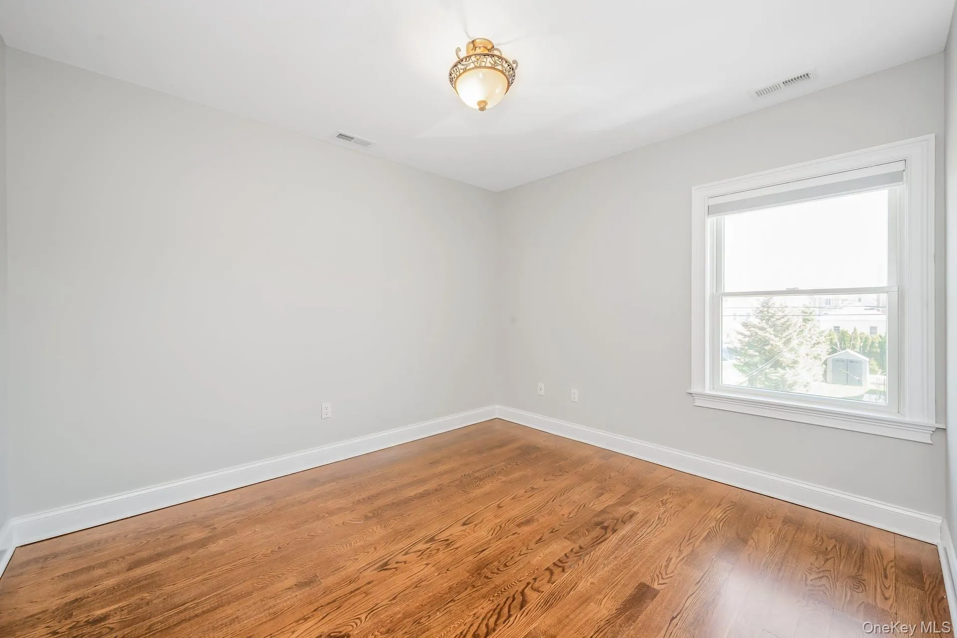 Unfurnished room with wood finished floors Unfurnished room with wood finished floors