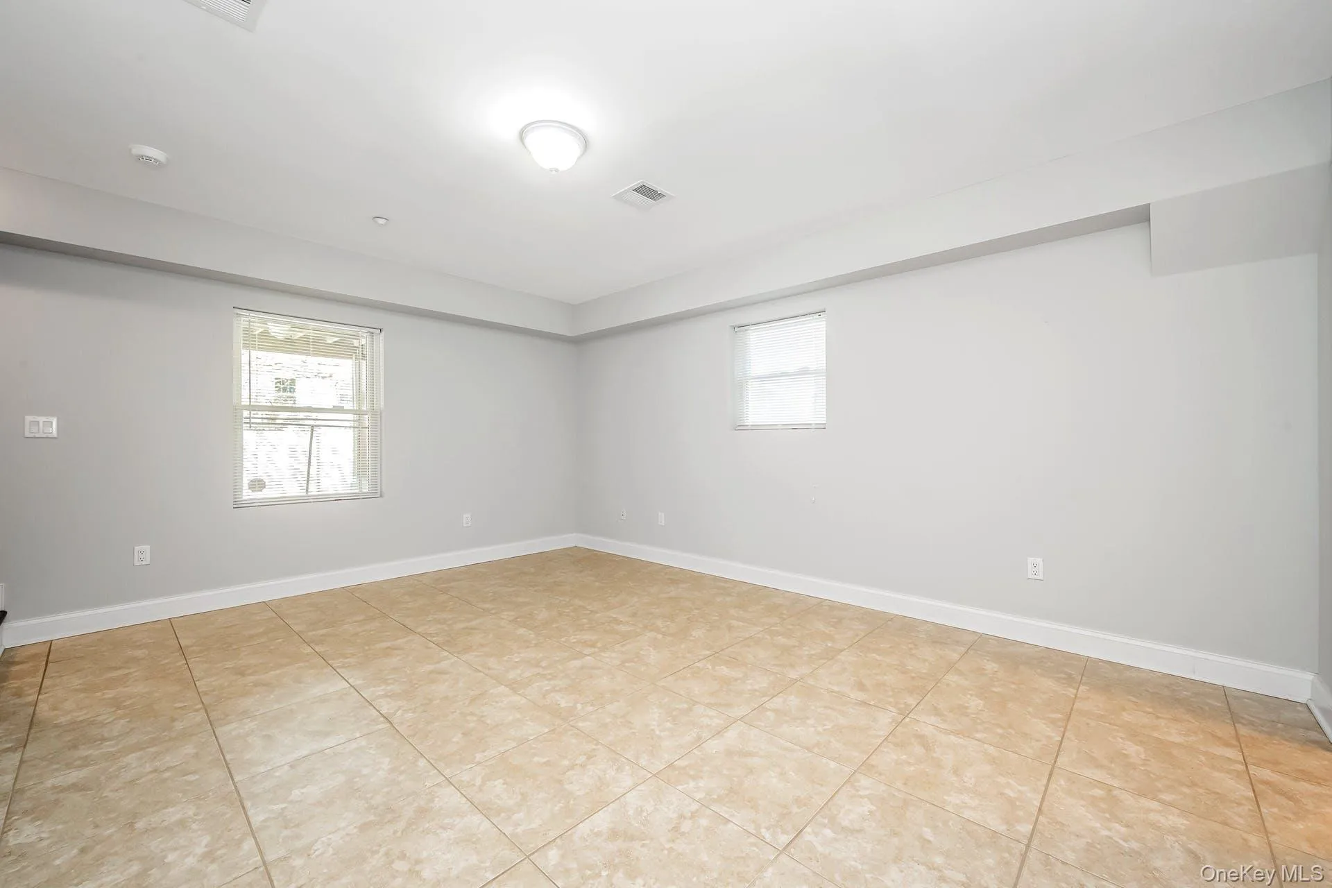 Unfurnished room featuring baseboards and light tile patterned floors Unfurnished room featuring baseboards and light tile patterned floors