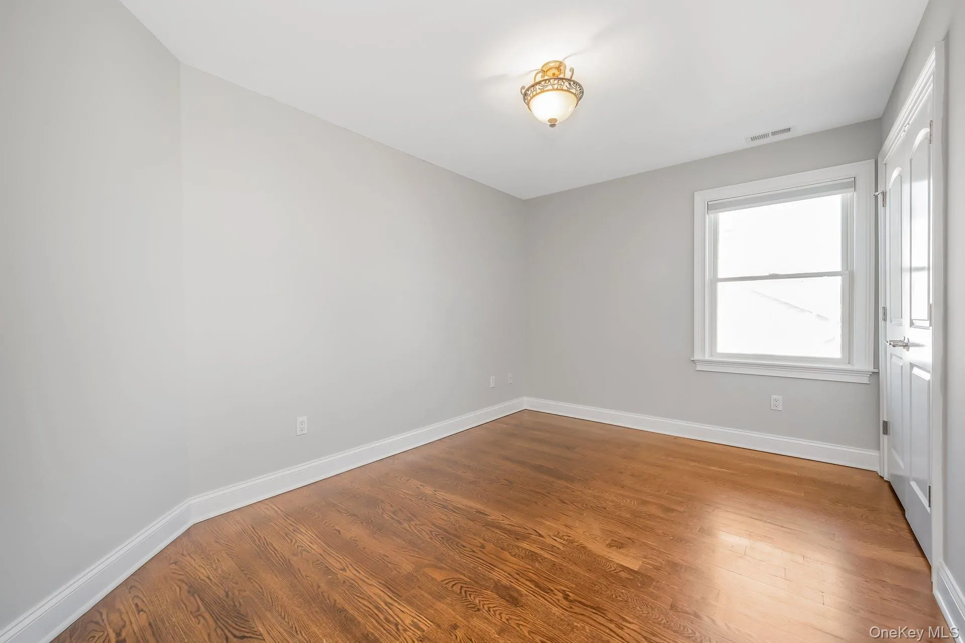 Unfurnished room with baseboards and light wood-style flooring Unfurnished room with baseboards and light wood-style flooring