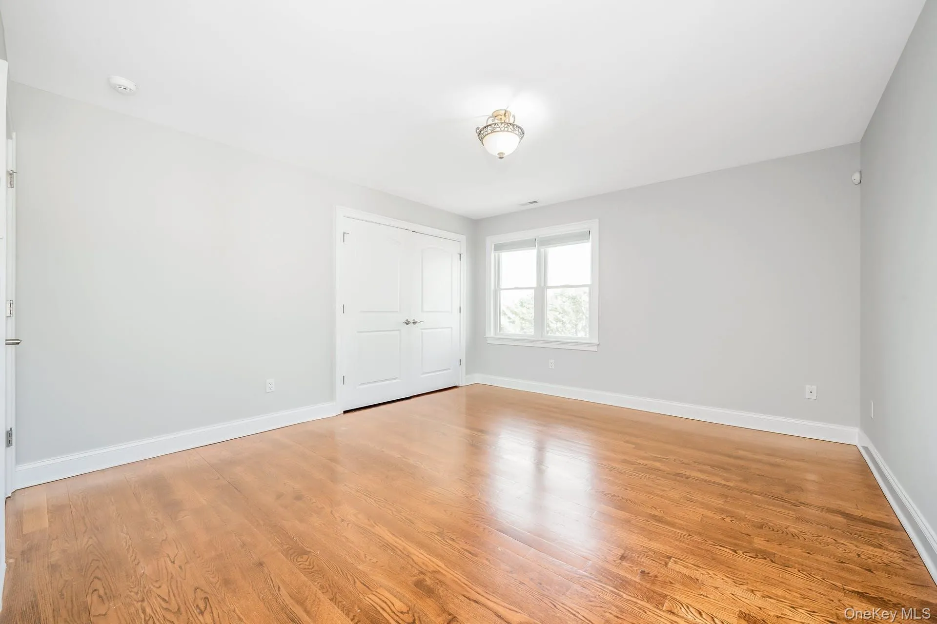 Unfurnished bedroom with light wood-style flooring and a closet Unfurnished bedroom with light wood-style flooring and a closet