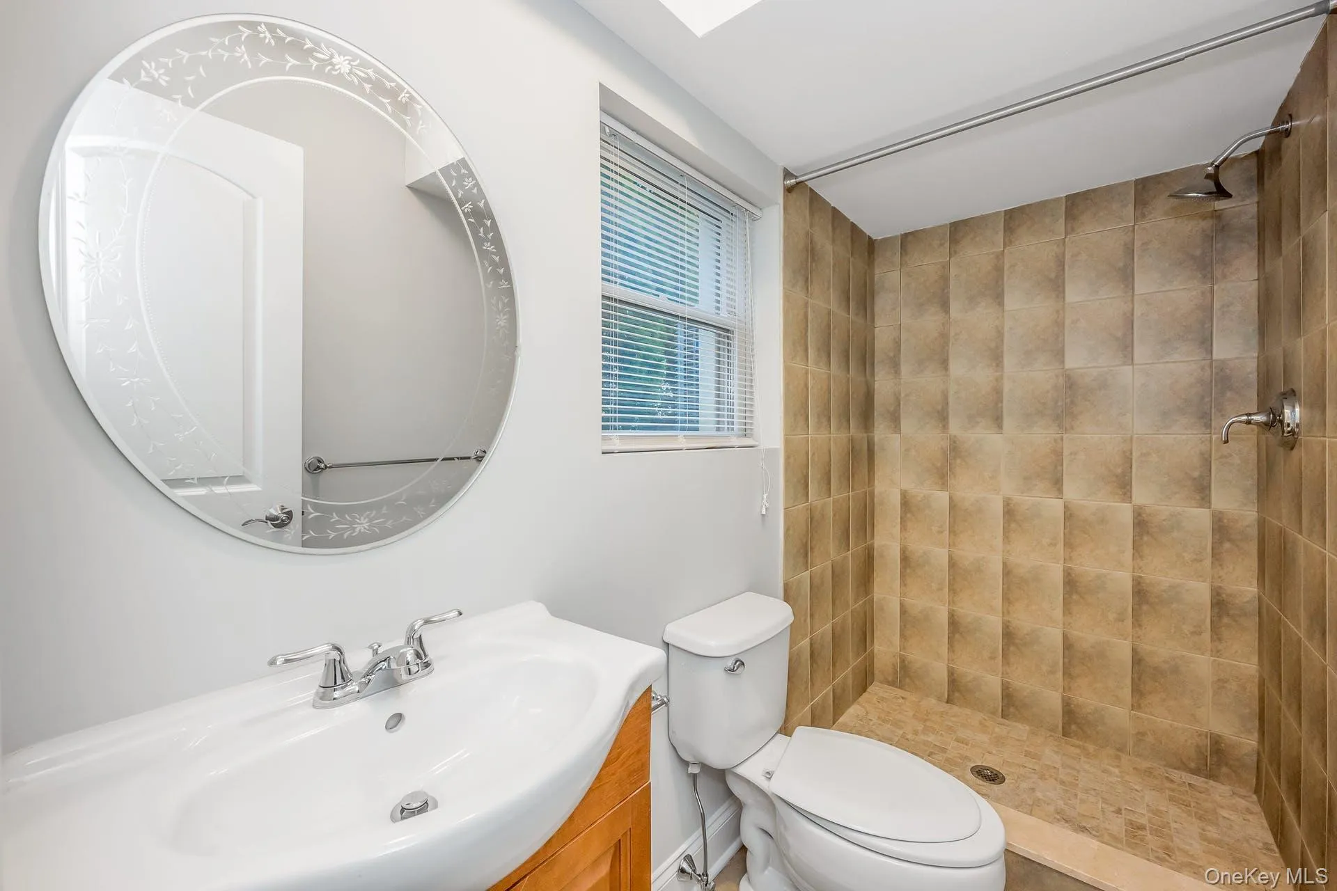 Bathroom featuring a shower stall and vanity Bathroom featuring a shower stall and vanity
