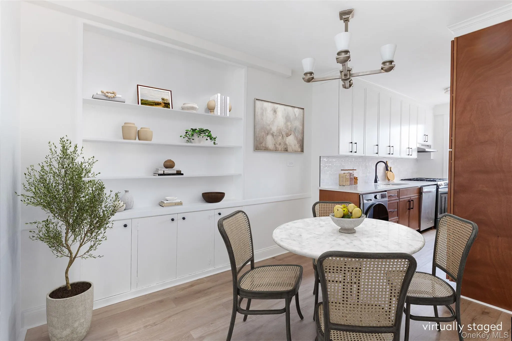 Dining area with light wood-style flooring and a chandelier Dining area with light wood-style flooring and a chandelier