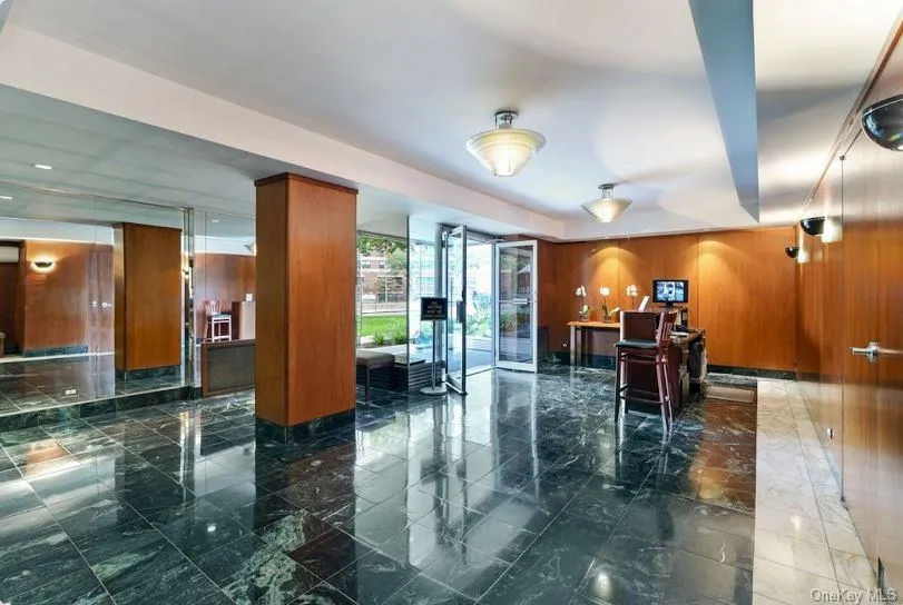 Common area featuring wood walls and expansive windows Common area featuring wood walls and expansive windows
