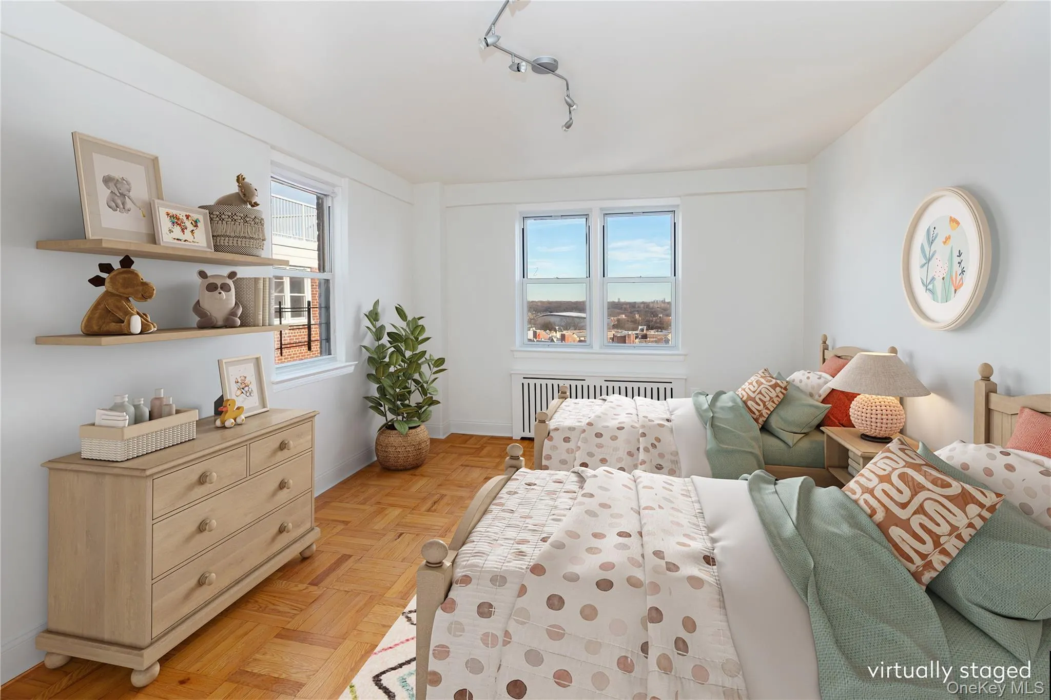 Bedroom featuring rail lighting and radiator heating unit Bedroom featuring rail lighting and radiator heating unit