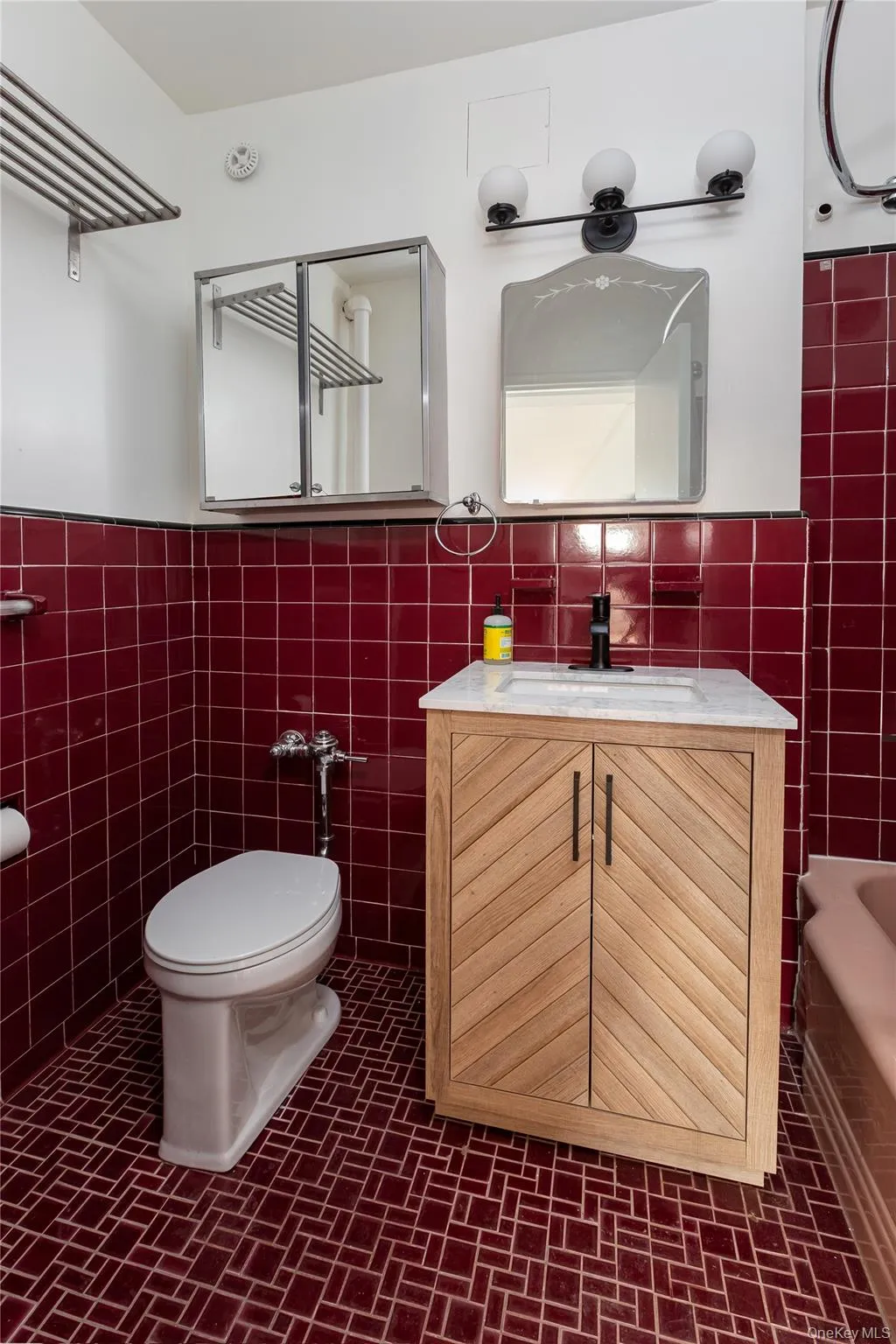 Bathroom featuring vanity, tile walls, wainscoting, and shower / washtub combination Bathroom featuring vanity, tile walls, wainscoting, and shower / washtub combination