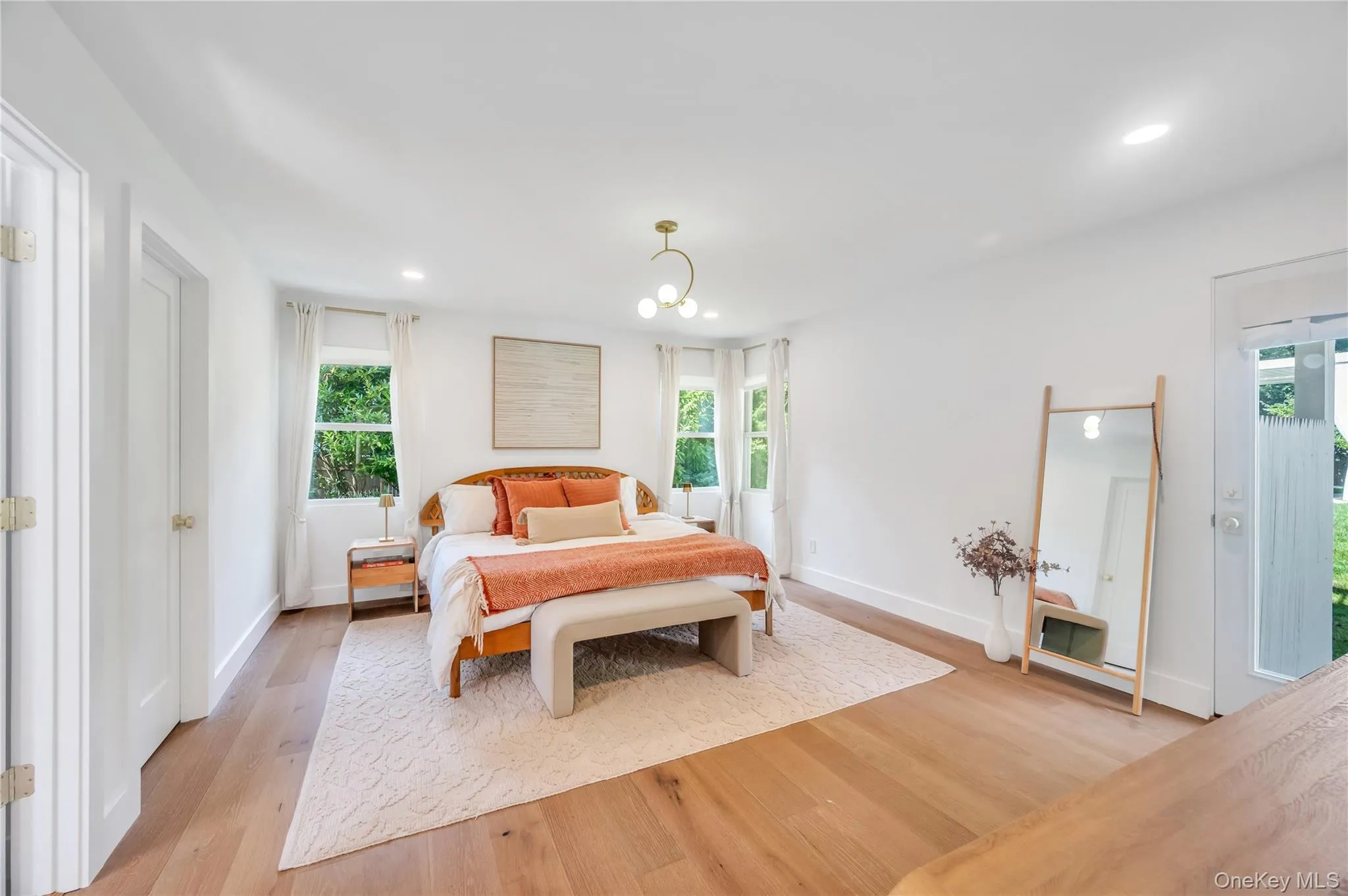Bedroom with light wood-style floors, access to exterior, recessed lighting, and multiple windows Bedroom with light wood-style floors, access to exterior, recessed lighting, and multiple windows