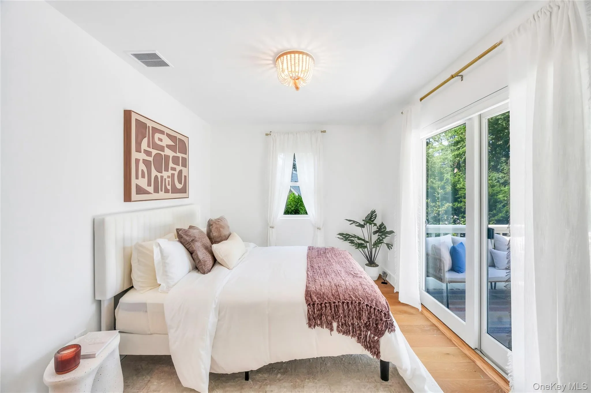 Bedroom featuring wood finished floors and access to outside Bedroom featuring wood finished floors and access to outside