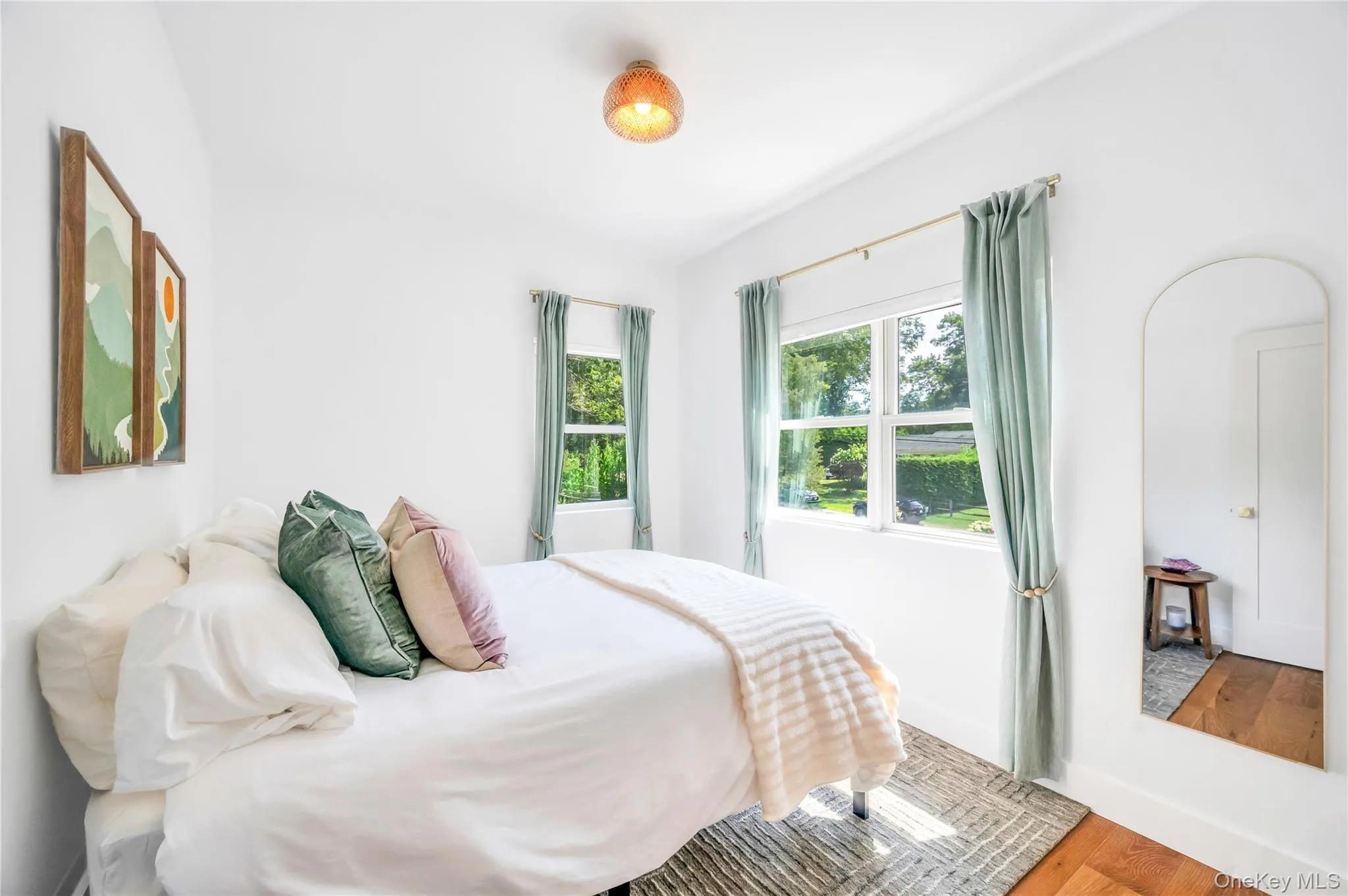 Bedroom with wood finished floors and baseboards Bedroom with wood finished floors and baseboards