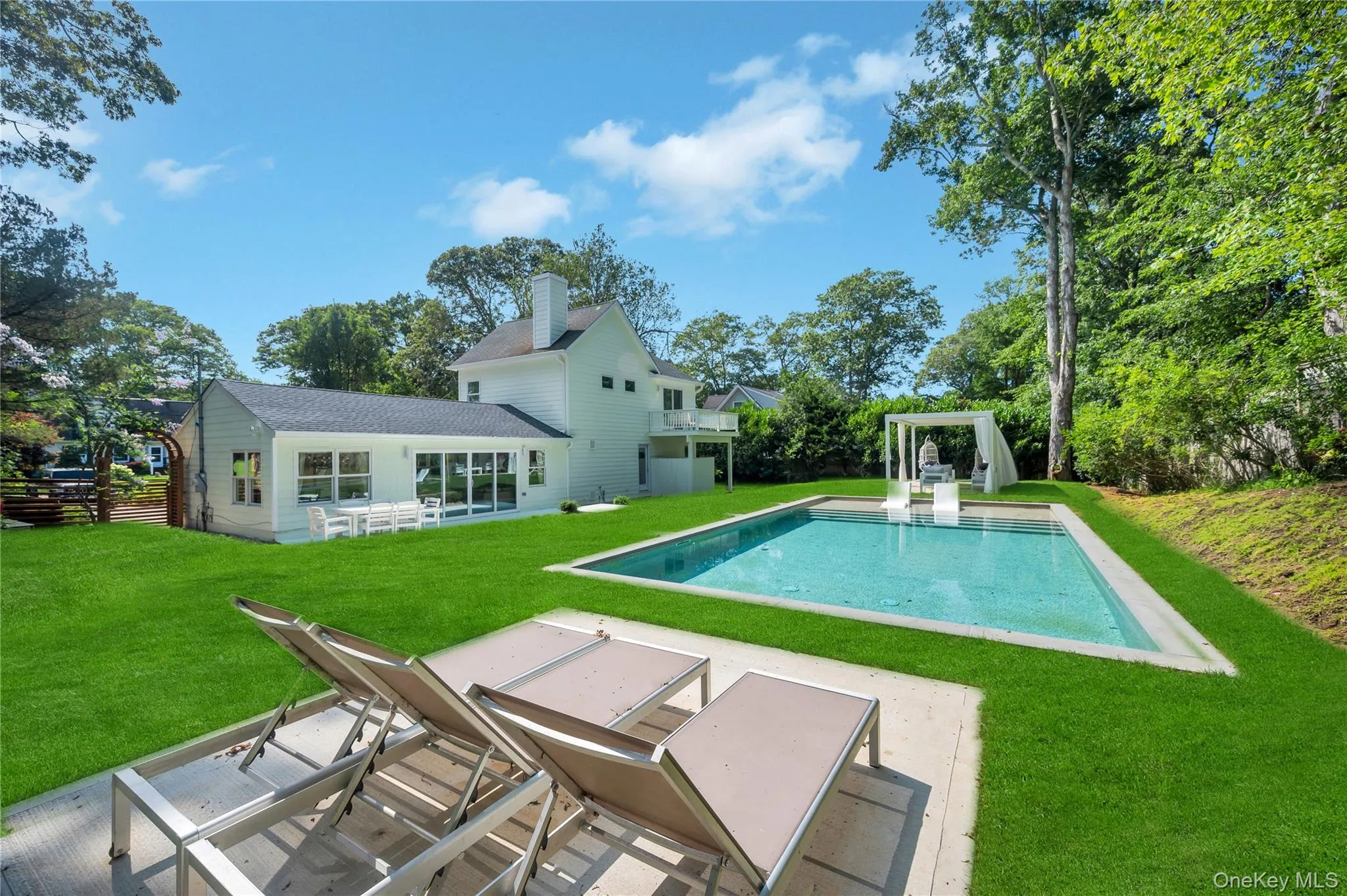 Outdoor pool featuring a patio area and a lawn Outdoor pool featuring a patio area and a lawn