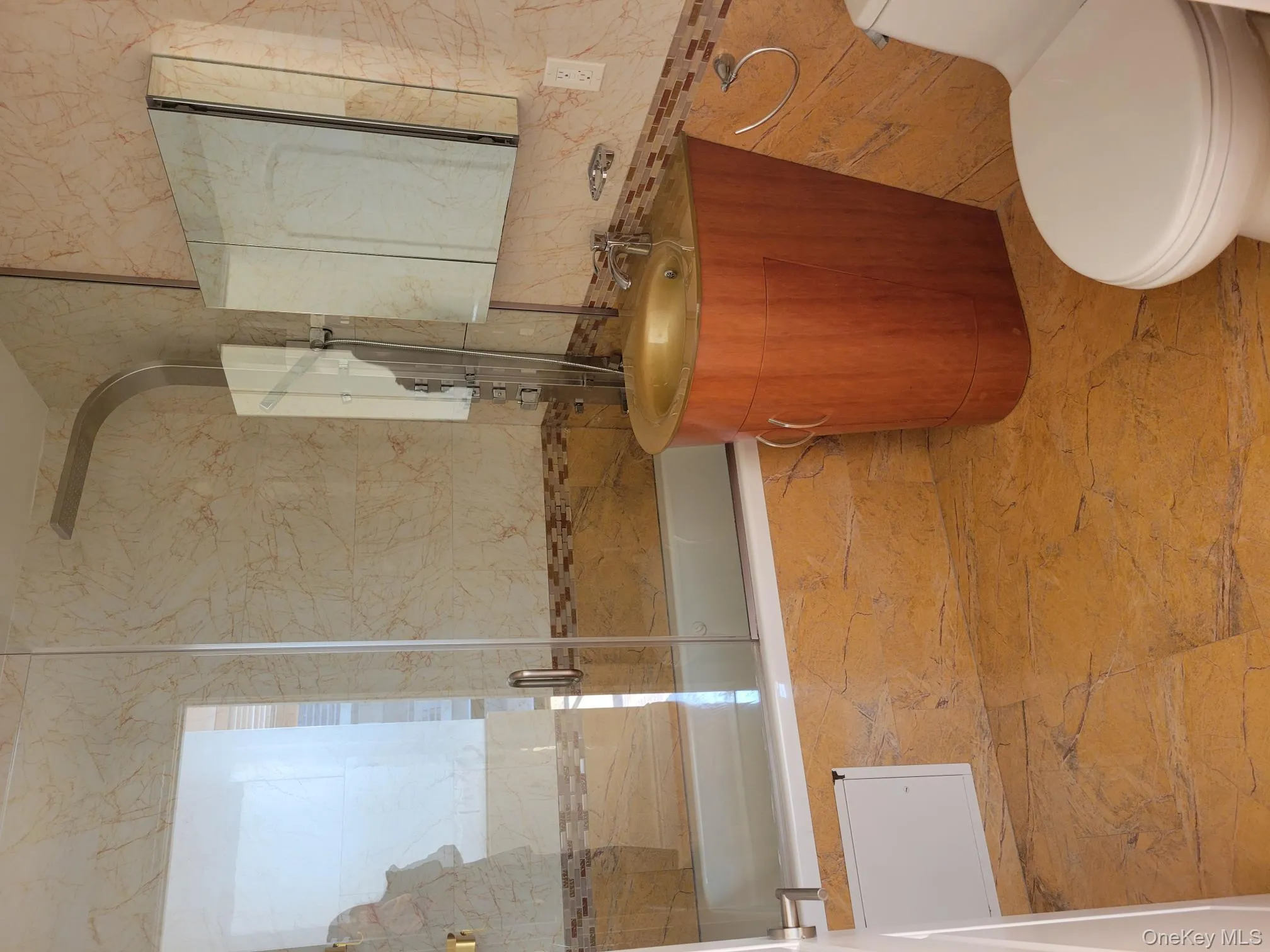 Full bath featuring vanity, tile walls, and tiled shower / bath Full bath featuring vanity, tile walls, and tiled shower / bath