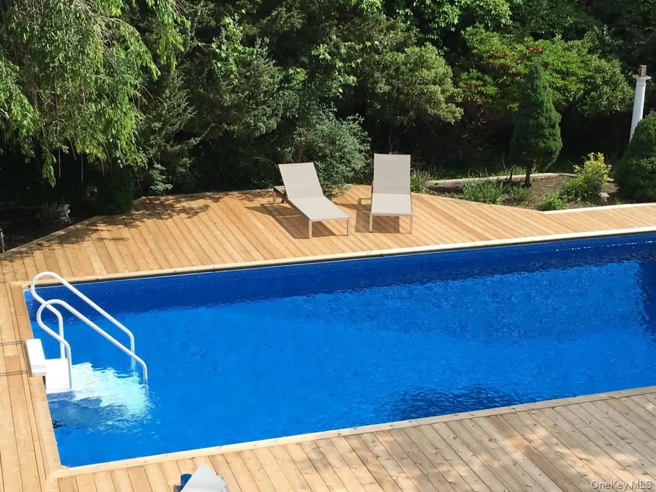 Swimming pool featuring a wooden deck Swimming pool featuring a wooden deck