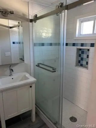 Full bath featuring vanity and a stall shower Full bath featuring vanity and a stall shower