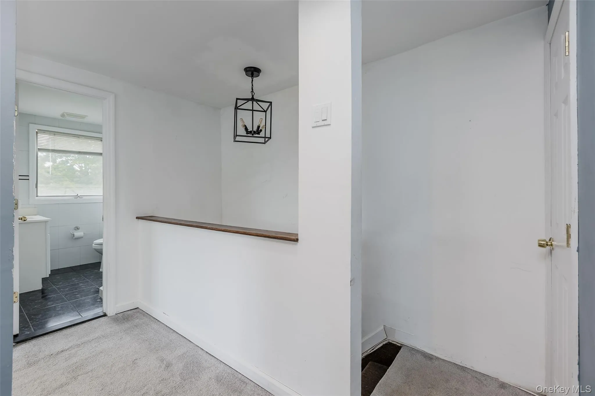 Hallway with carpet flooring and baseboards Hallway with carpet flooring and baseboards