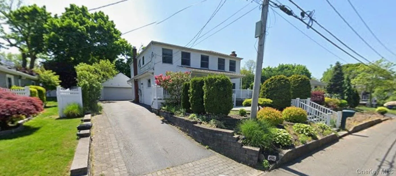 Traditional home with a detached garage and a chimney Traditional home with a detached garage and a chimney