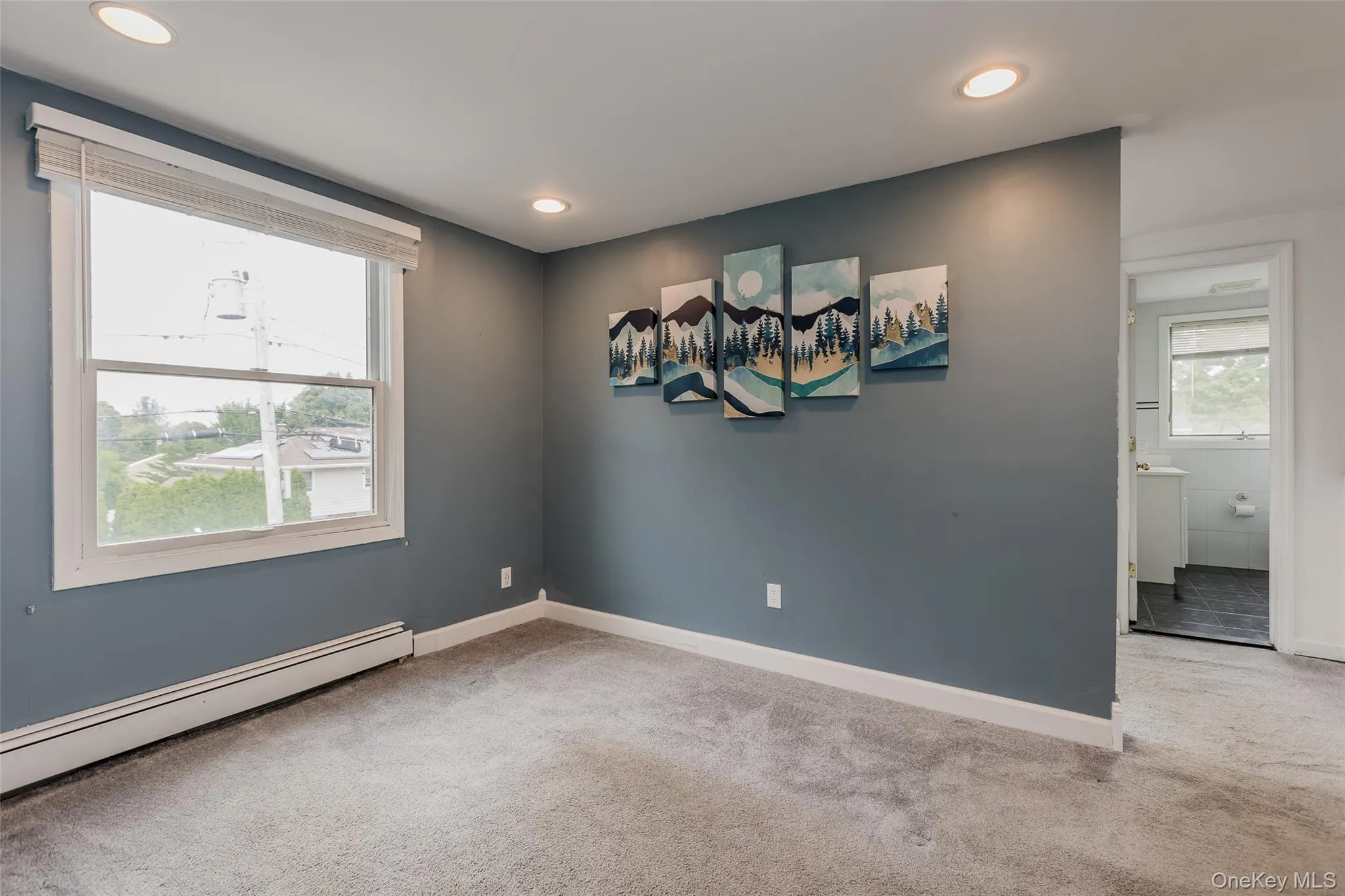 Spare room featuring light carpet, baseboard heating, and recessed lighting Spare room featuring light carpet, baseboard heating, and recessed lighting