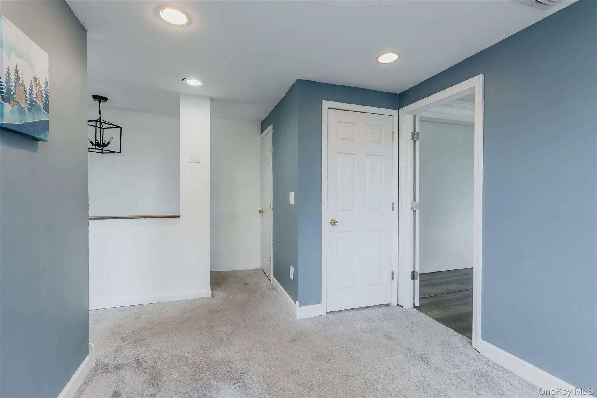Hallway with carpet floors and recessed lighting Hallway with carpet floors and recessed lighting