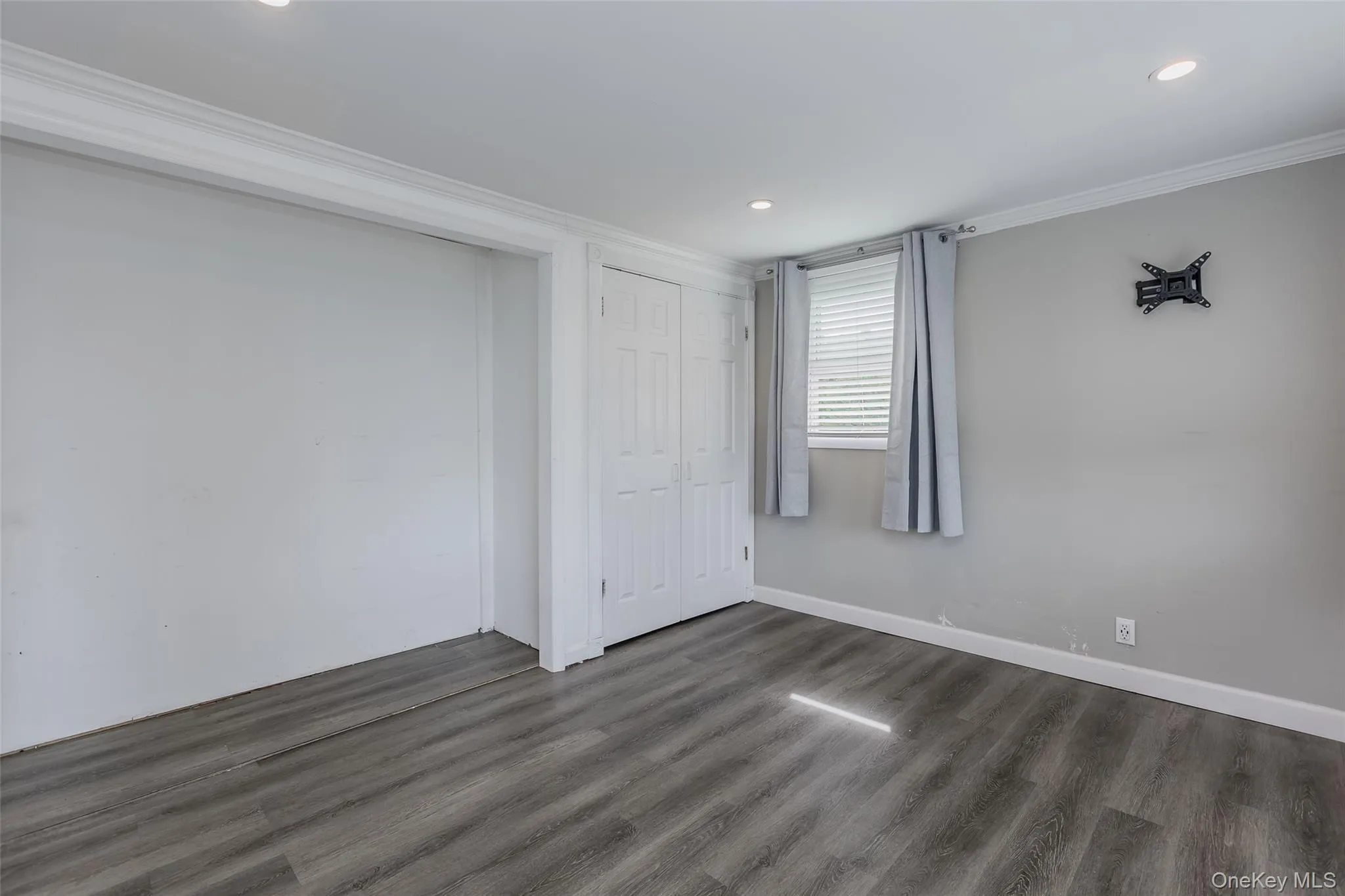 Unfurnished bedroom featuring dark wood-style floors, crown molding, and recessed lighting Unfurnished bedroom featuring dark wood-style floors, crown molding, and recessed lighting